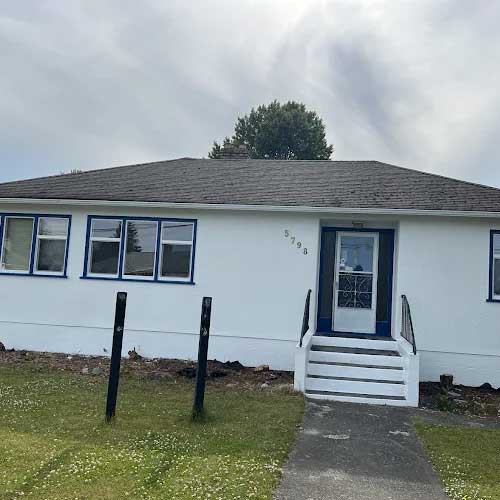 Crisp white siding with navy trim